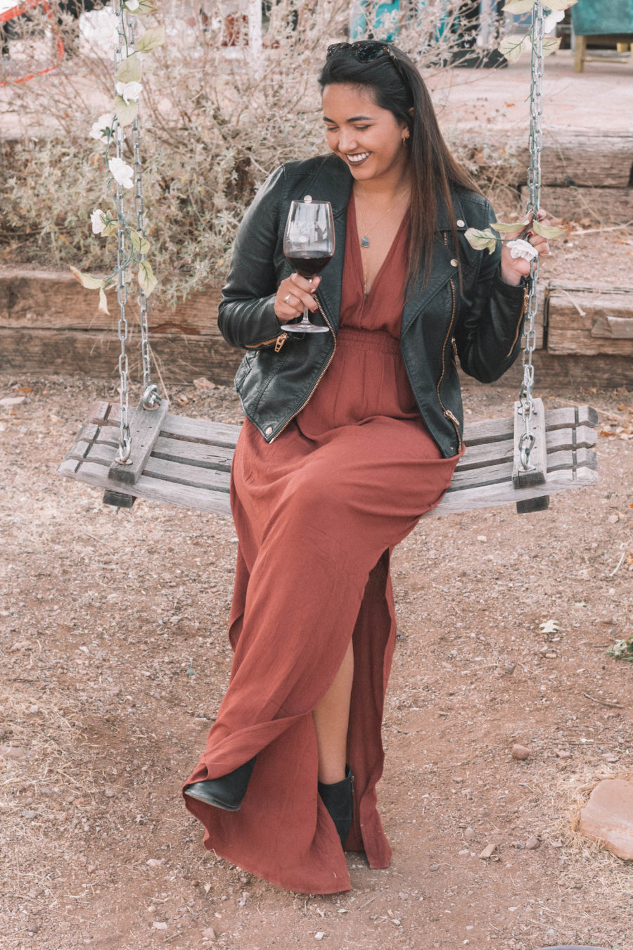 The perfect wine tasting outfit features a long dress and a moto jacket for some added edge!