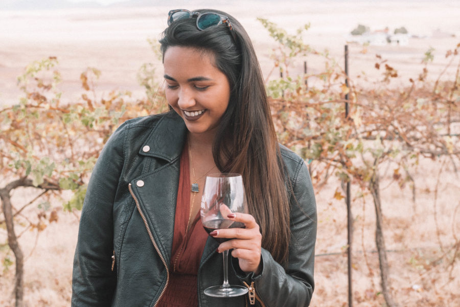The perfect wine tasting outfit features a long dress and a moto jacket for some added edge!